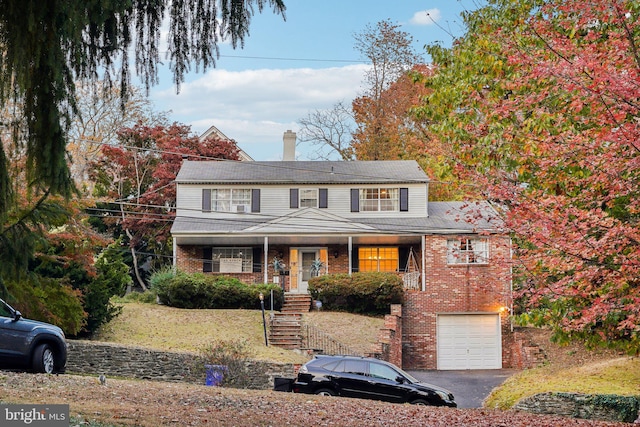 view of front of home featuring a porch and a garage