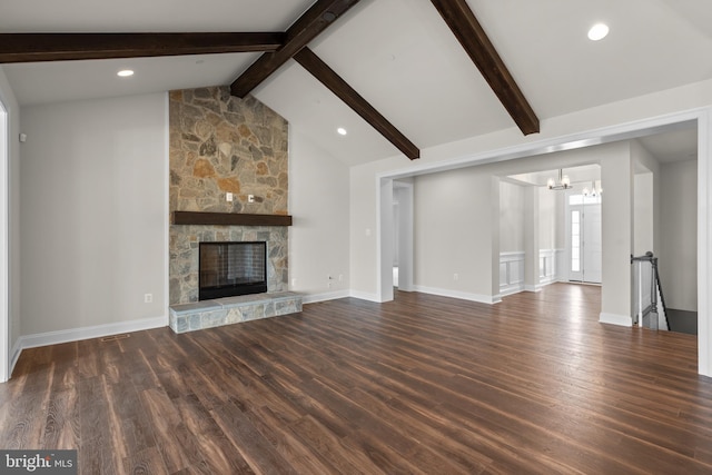 unfurnished living room featuring vaulted ceiling with beams, a chandelier, a stone fireplace, and dark hardwood / wood-style flooring