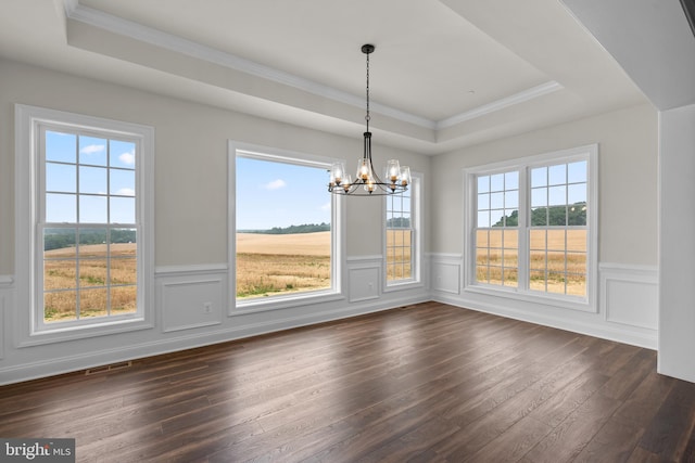 unfurnished dining area featuring a wealth of natural light, a tray ceiling, and dark hardwood / wood-style flooring