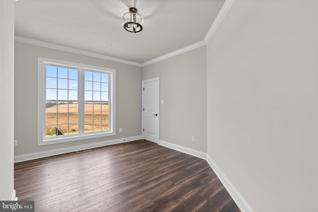 empty room with ornamental molding and dark hardwood / wood-style floors