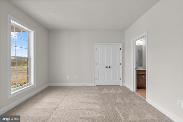14628 Old Hanover Rd Regi, Unit Regi, Reisterstown, MD 21136 - unfurnished bedroom featuring ensuite bath, carpet floors, baseboards, and a closet