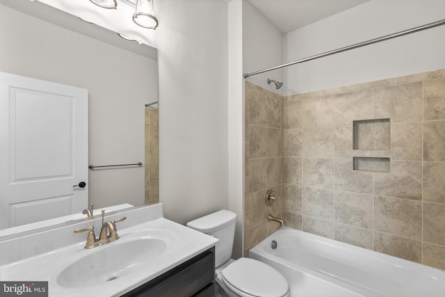 full bathroom with toilet, tiled shower / bath combo, and vanity