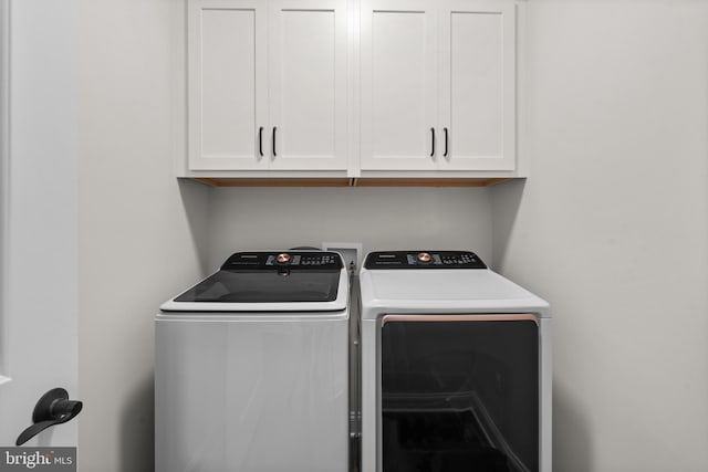 laundry area featuring cabinets and washer and dryer