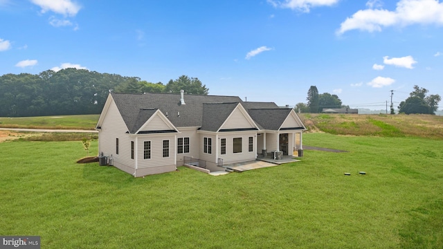 back of property with a patio, central AC, and a yard