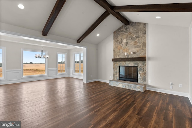 unfurnished living room with dark wood-type flooring, vaulted ceiling with beams, and a fireplace