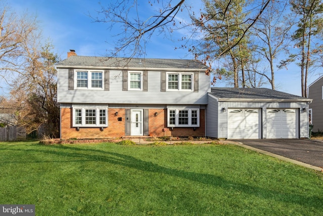 view of front facade featuring a front yard and a garage