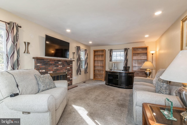 living room featuring carpet and a fireplace