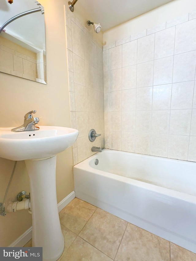 bathroom with tile patterned floors and tiled shower / bath