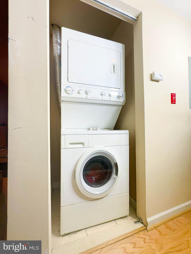 washroom with stacked washer / dryer