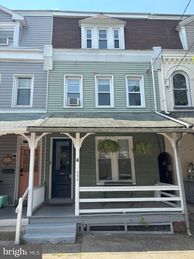 view of property with cooling unit and a porch