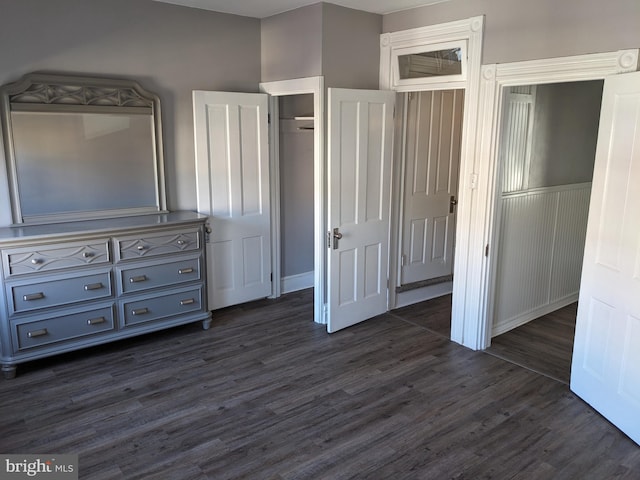 unfurnished bedroom with dark hardwood / wood-style flooring