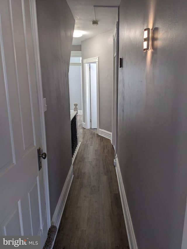 corridor featuring dark hardwood / wood-style flooring