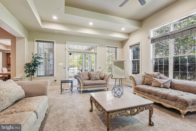 living room with ceiling fan, carpet flooring, and plenty of natural light