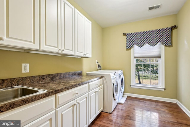 708 Church Rd S, Upper Marlboro, MD 20774 - washroom featuring cabinet space, wood finished floors, visible vents, separate washer and dryer, and baseboards