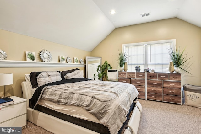 bedroom featuring light colored carpet and vaulted ceiling