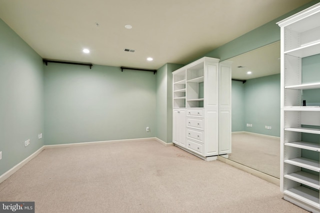 spare room featuring light colored carpet