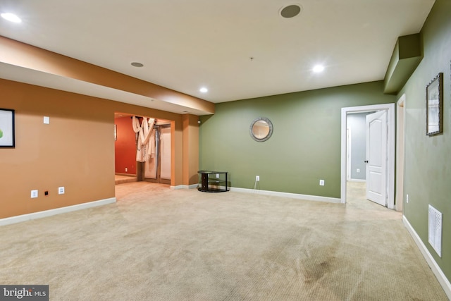 basement featuring light colored carpet