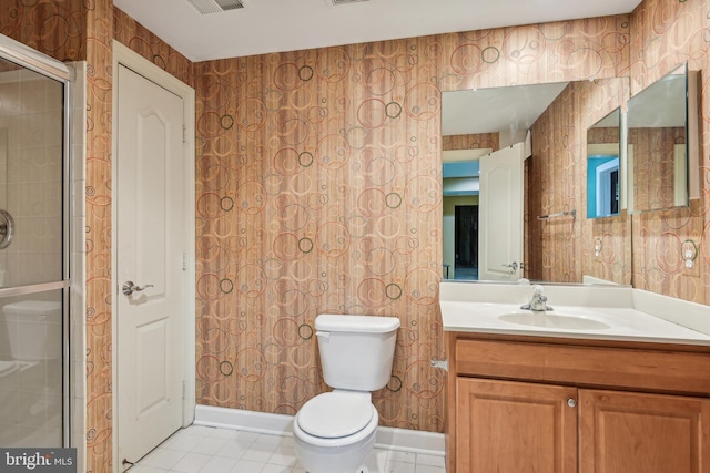 bathroom with vanity, toilet, tile patterned floors, and walk in shower