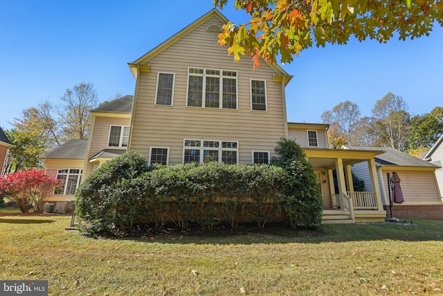 rear view of house featuring a lawn