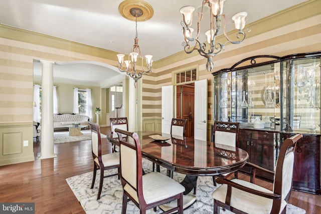 708 Church Rd S, Upper Marlboro, MD 20774 - dining space with wallpapered walls, ornamental molding, decorative columns, a chandelier, and a wainscoted wall