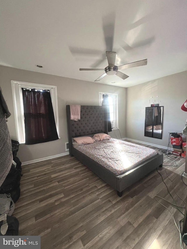 bedroom with dark hardwood / wood-style floors and ceiling fan