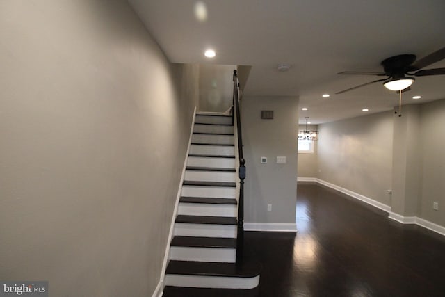 staircase featuring hardwood / wood-style flooring and ceiling fan