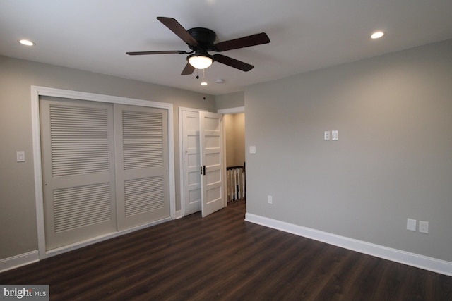 unfurnished bedroom with a closet, dark hardwood / wood-style floors, and ceiling fan