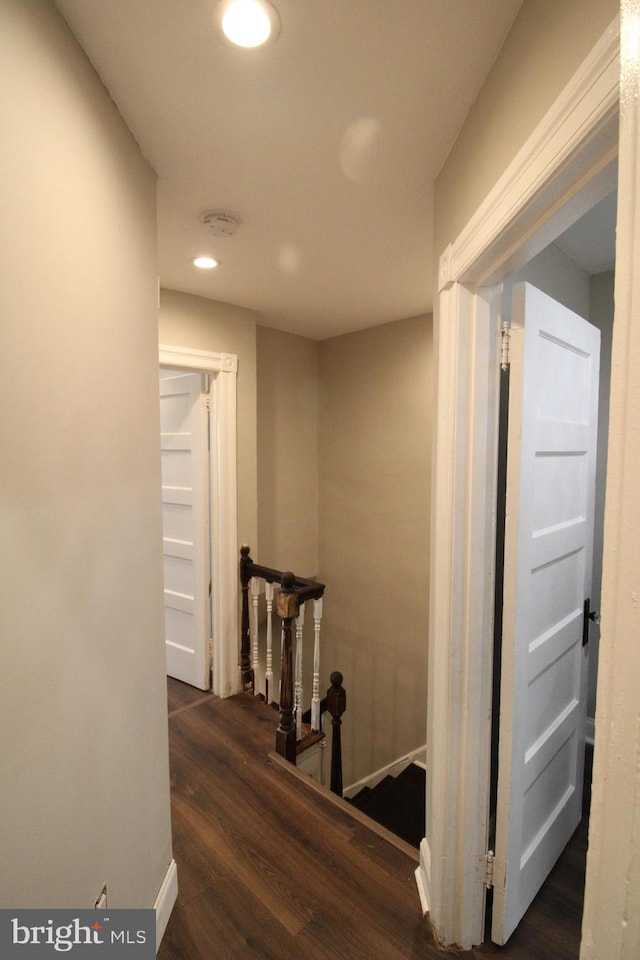 corridor with dark hardwood / wood-style floors