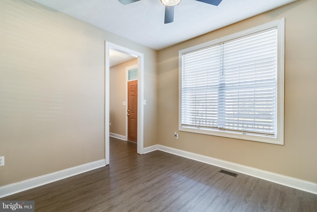 empty room featuring ceiling fan and dark hardwood / wood-style flooring