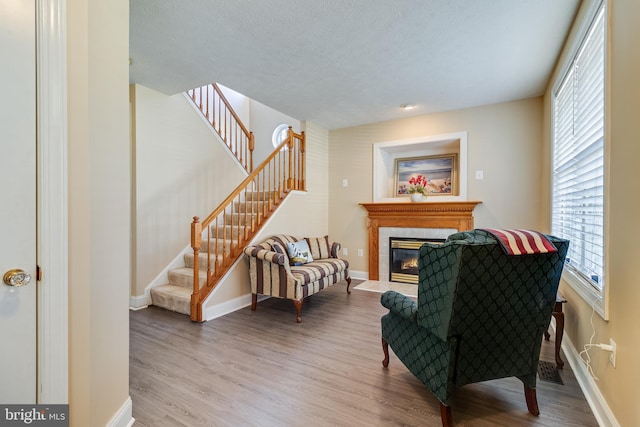 sitting room with wood-type flooring and a textured ceiling