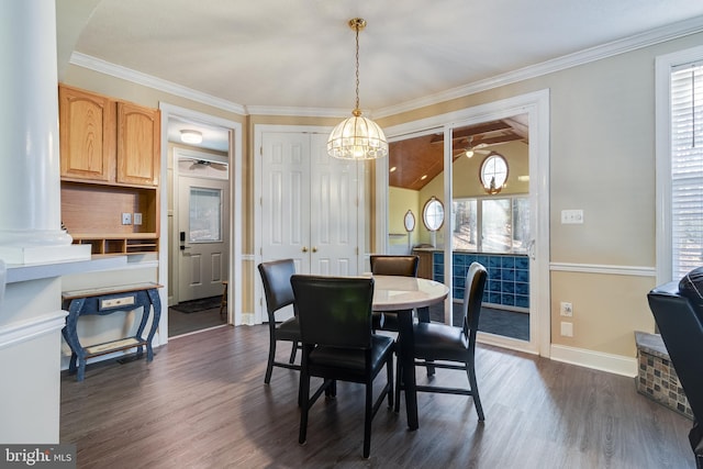 dining space featuring crown molding, vaulted ceiling, ceiling fan, ornate columns, and dark hardwood / wood-style flooring