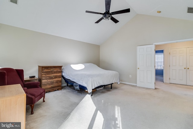 carpeted bedroom featuring high vaulted ceiling and ceiling fan