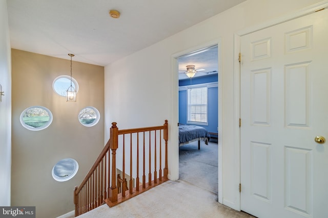 hall featuring light colored carpet