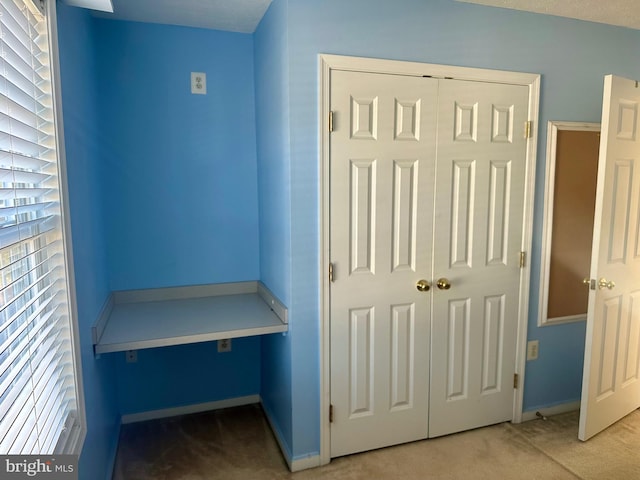 interior space featuring carpet flooring and a textured ceiling