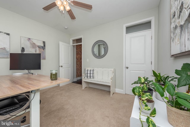 carpeted office space featuring ceiling fan