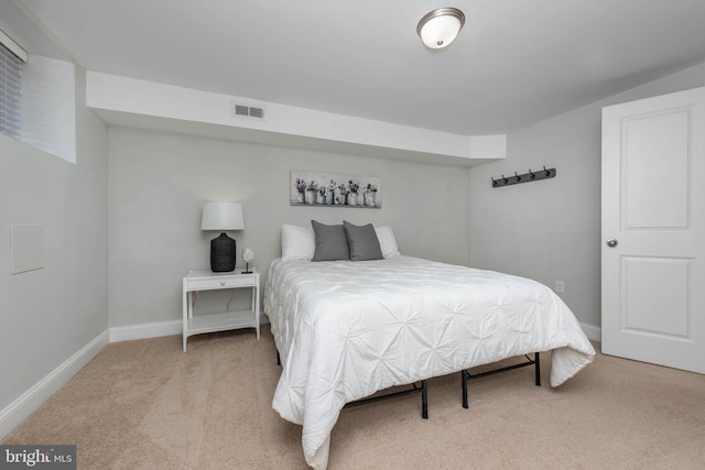 bedroom featuring light carpet