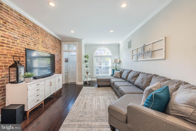 living room with ornamental molding, dark hardwood / wood-style floors, and brick wall