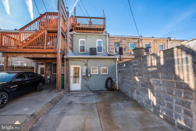 back of house featuring central AC unit