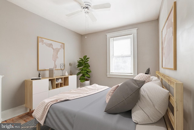 bedroom with wood-type flooring and ceiling fan