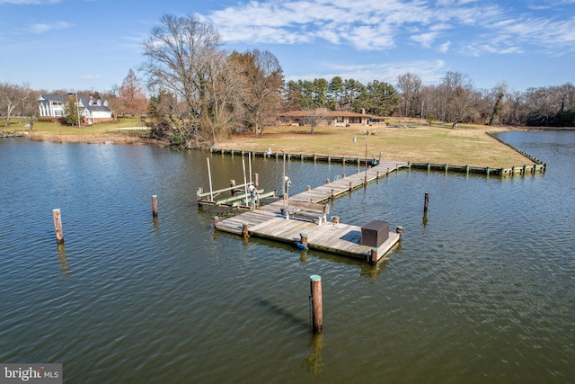 view of dock featuring a water view and a yard