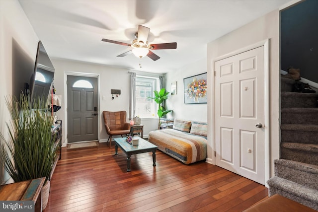 living room with dark hardwood / wood-style floors and ceiling fan