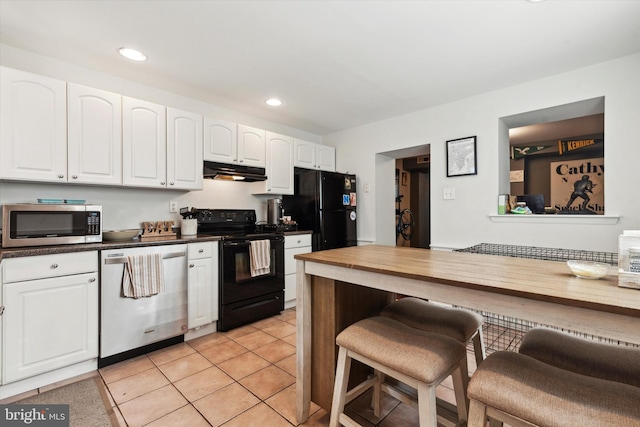 kitchen featuring light tile patterned flooring, white cabinetry, and black appliances