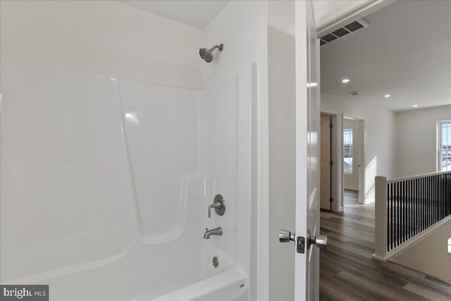 bathroom with tub / shower combination and hardwood / wood-style flooring