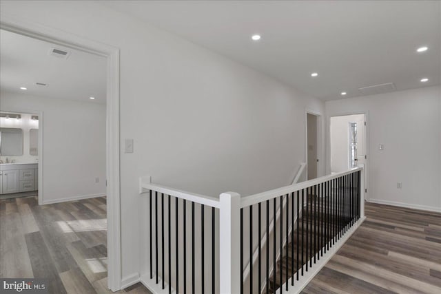 hallway with sink and hardwood / wood-style floors