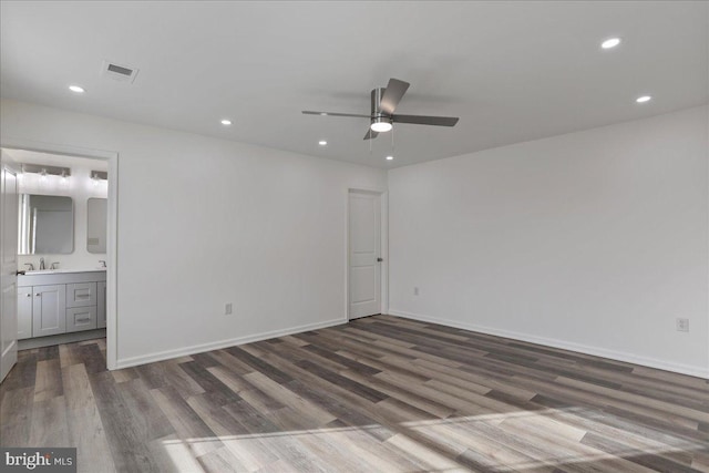 unfurnished bedroom with ceiling fan, sink, connected bathroom, and dark hardwood / wood-style floors