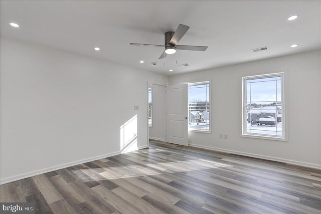 empty room with hardwood / wood-style floors and ceiling fan