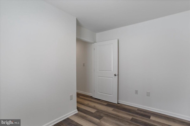 empty room with dark hardwood / wood-style floors