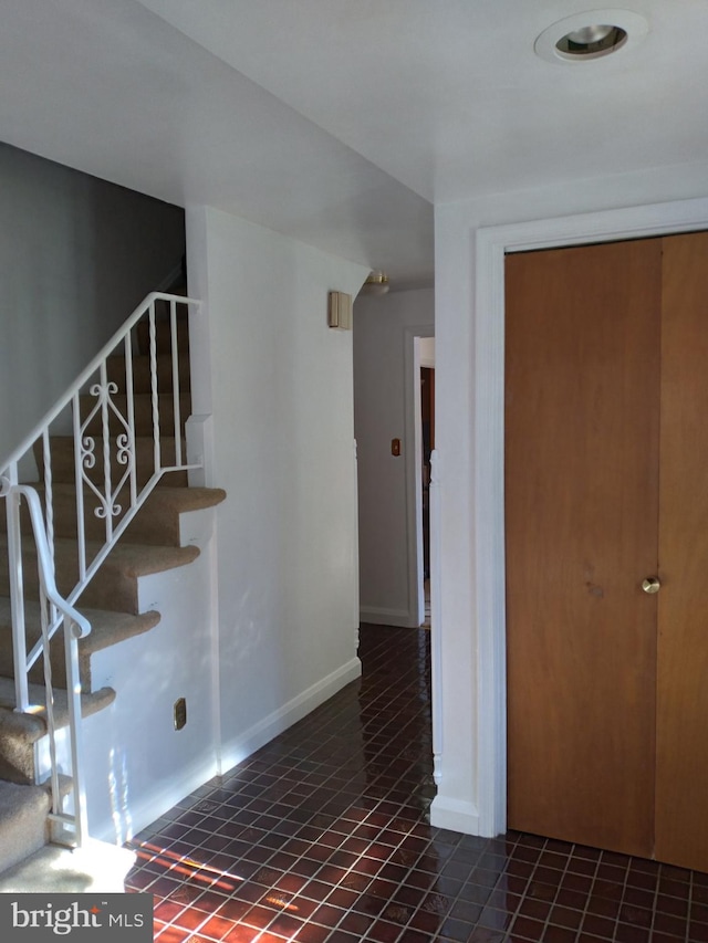 stairs with tile patterned floors