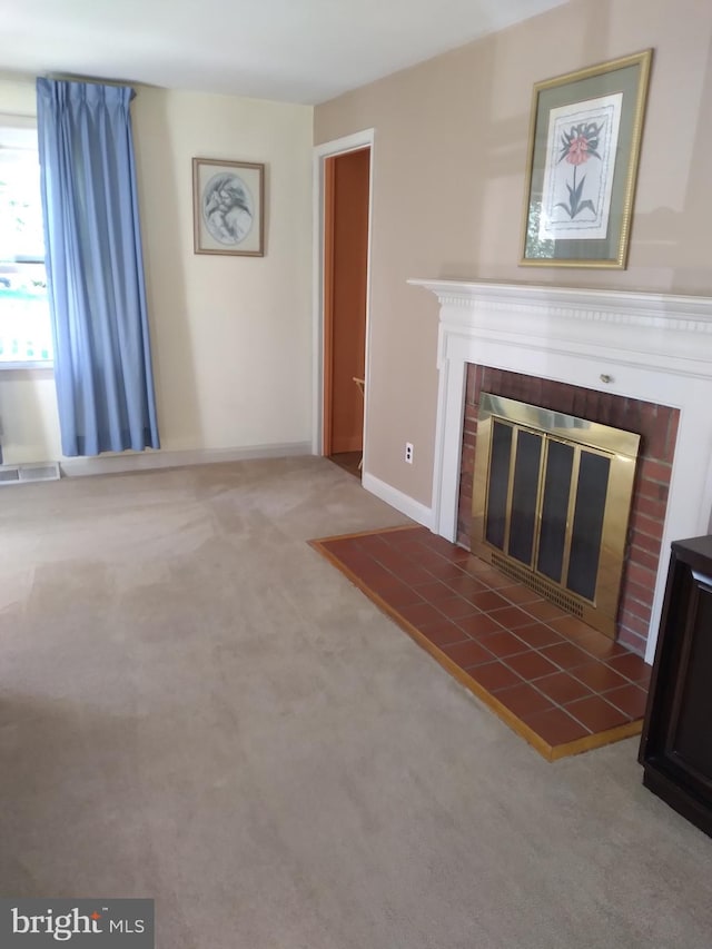 unfurnished living room with carpet floors and a fireplace