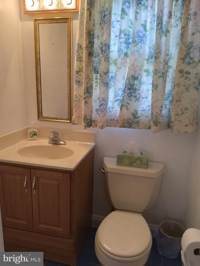 bathroom with vanity, toilet, and tile patterned flooring